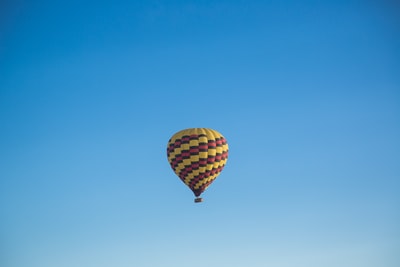 黄色和粉色的热气球漂浮在蓝天白天
